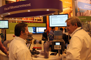 Shane Hale (l) explains the ease of use built into the 370XA gas chromatograph at OTC 2014.
