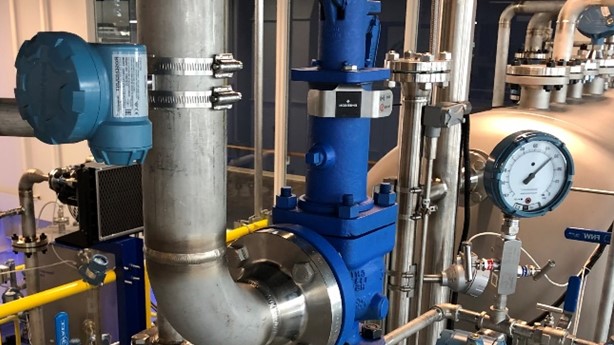 An acoustic transmitter (blue device in the upper left of the photo), can be mounted on the discharge pipe of a PRV, allowing it to detect the vibrations caused by any release. These devices send data via WirelessHART.